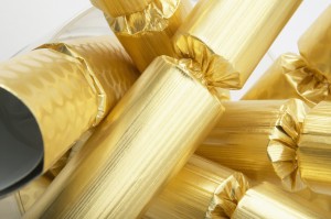Detail view of a pile of gold Christmas crackers