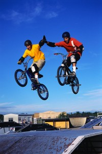 Dirt Bikers Giving High Five During Jump