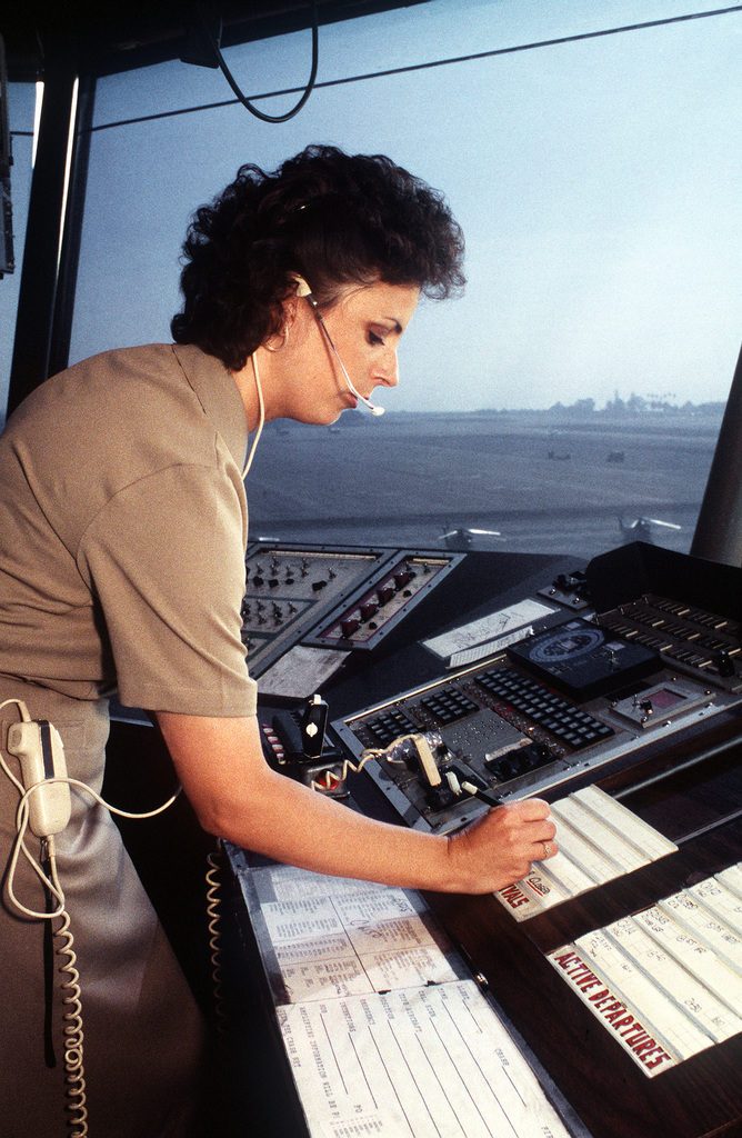 Air Traffic Controlman Third Class (ACC) Wendy Parrett list a new aircraft arrival from her local control position in the air traffic control tower at Naval Air Station North Island. Photo by PH2 Eric A. Clement