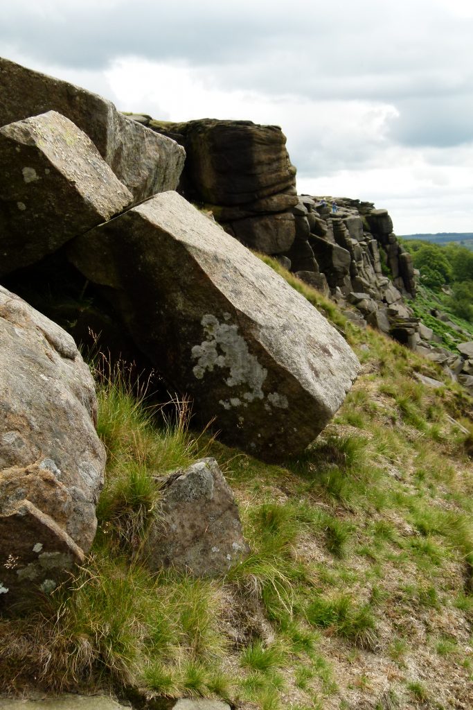 Photo of a square boulder leaning on another on Stanage Edge.