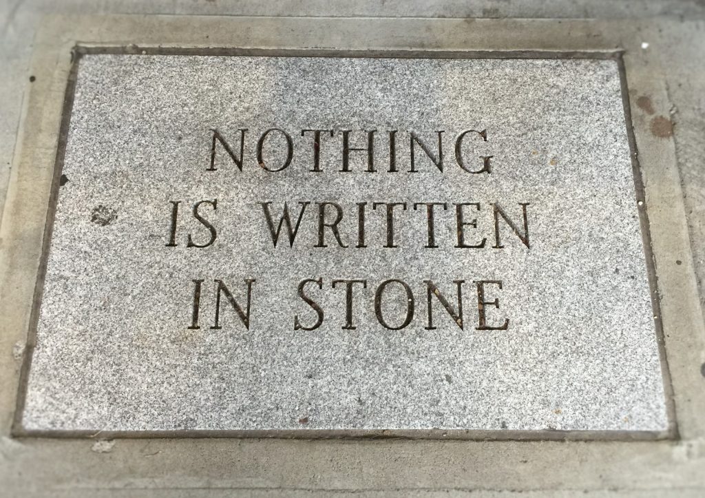 A sign, written in stone, saying "Nothing is written in stone"